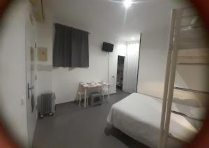 a bedroom with a bunk bed and a table with chairs at Hostel Urban Sevilla in Seville +50 photos