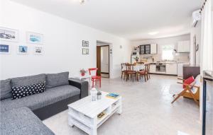 a living room with a couch and a table at Lovely Home In Sibenik With Kitchen in Šibenik
