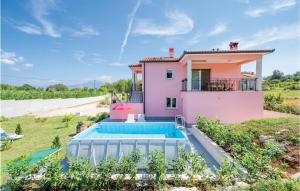 a villa with a swimming pool in front of a house at Nice Apartment In Boljevici With Wifi in Kršan