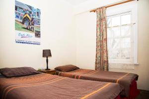 Postel nebo postele na pokoji v ubytování Jikeleza Lodge