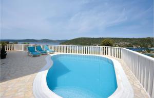 a swimming pool on the deck of a house at 4 Bedroom Lovely Home In Drvenik Veliki in Drvenik Veli