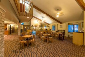 a restaurant with tables and chairs in a room at AmericInn by Wyndham Minocqua in Minocqua