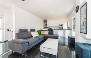 a living room with a couch and a table at Three-Bedroom Holiday Home In Brodarica in Brodarica