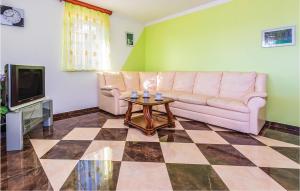a living room with a couch and a table at Awesome Apartment In Tisno With 2 Bedrooms And Wifi in Tisno