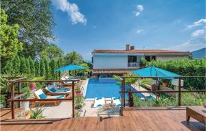 a villa with a swimming pool and a house at Stunning Home In Icici With Outdoor Swimming Pool in Ičići