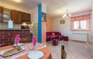 a kitchen and living room with a table in a room at Awesome Apartment In Zminj With 2 Bedrooms And Wifi in Žminj
