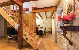 a wooden staircase in a room with a table at Gorgeous Home In Kringa With Outdoor Swimming Pool in Kringa