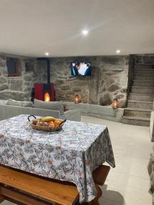 a room with a table with a bowl of fruit on it at BezerreiraComVida-O refúgio do monte in Bezerreira