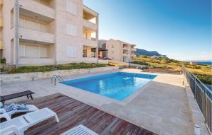 a swimming pool in front of a building at Pet Friendly Apartment In Pag With Outdoor Swimming Pool in Pag