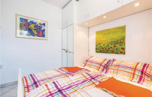 a bedroom with a bed and a painting on the wall at Gorgeous Apartment In Rijeka With House Sea View in Rijeka