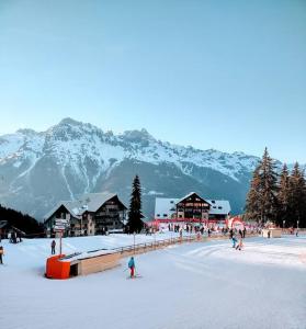 a group of people skiing on a snow covered mountain at Superbe appartement de 62 m2 au pied des pistes in Oz