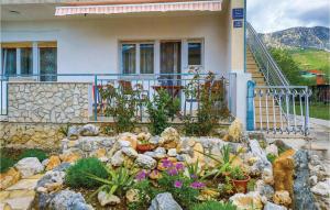 a house with a rock garden in front of it at 2 Bedroom Lovely Apartment In Kastel Kambelovac in Kaštela