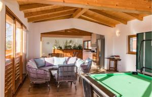 a living room with a pool table and chairs at Awesome Home In Marcana With Kitchen in Orbanići