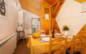 a dining room with a yellow table and chairs at 2 Bedroom Gorgeous Apartment In Drazice in Dražice