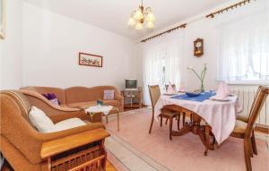 a living room with a couch and a table at Pet Friendly Apartment In Dramalj With House Sea View in Dramalj