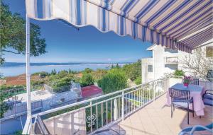 a balcony with a table and chairs and a view of the ocean at Pet Friendly Apartment In Dramalj With House Sea View in Dramalj