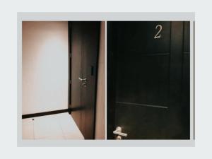 a black door with the number two in a hallway at Ecusuites Room 44 bellini Gye Santa Ana in Guayaquil +22 photos