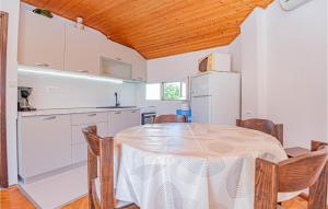 a kitchen with a table and chairs in a room at Pet Friendly Apartment In Jadrija With Wifi in Jadrija