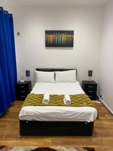 a bedroom with a large bed with two night stands at Wns HOTEL in London