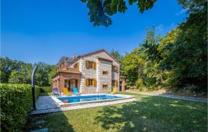 an exterior view of a house with a swimming pool at Lovely Home In Dolinci With Outdoor Swimming Pool in Grižane
