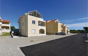 a building with a car parked in a parking lot at Amazing Apartment In Vodice With 1 Bedrooms And Wifi in Vodice