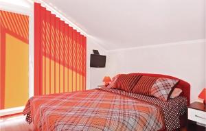 a bedroom with a bed and a tv on the wall at Amazing Apartment In Vodice With 1 Bedrooms And Wifi in Vodice