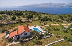 an aerial view of a house with a swimming pool at Lovely Home In Postira With House Sea View in Postira