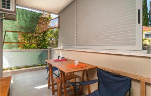 a small table and chairs on a balcony with a window at Nice Apartment In Stari Grad With Wifi in Stari Grad