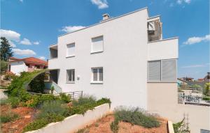 a white house with a garden in front of it at Nice Apartment In Stari Grad With Wifi in Stari Grad +13 photos