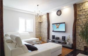 uma sala de estar com um sofá branco e uma parede de tijolos em Amazing Home In Sumet With 3 Bedrooms, Wifi And Outdoor Swimming Pool em Šumet