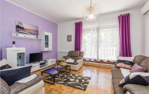a living room with purple walls and purple curtains at 2 Bedroom Awesome Apartment In Matulji in Matulji