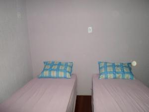 Un pat sau paturi într-o cameră la Assel Pousada Xaxim