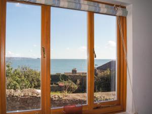 a window with a view of the ocean at Chough Cottage in Cawsand