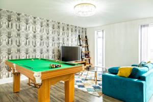 a living room with a pool table and a couch at Attractive 2 Bedroom Penthouse with free Parking in Romford
