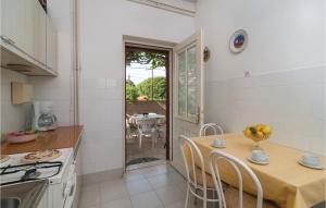 a kitchen with a table and a dining room at Stunning Apartment In Supetar With 2 Bedrooms And Wifi in Supetar