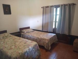 a bedroom with two beds and a window at ITALIA RANCH in Punta del Este