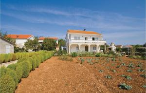 a large white house with a garden of vegetables at Nice Apartment In Vir With 3 Bedrooms in Vir