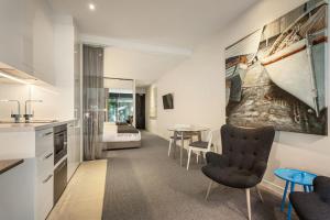 a living room with a kitchen and a bedroom at Quest Frankston on the Bay in Frankston