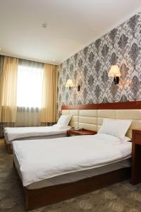 Ένα ή περισσότερα κρεβάτια σε δωμάτιο στο Guide Hotel