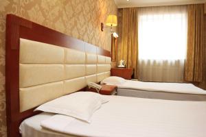 Voodi või voodid majutusasutuse Guide Hotel toas