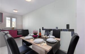 a dining room with a table and chairs and a kitchen at Beautiful Apartment In Cizici With Wifi in Čižići