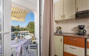 a kitchen with a table and a view of a balcony at Nice Apartment In Gabonjin With 1 Bedrooms And Wifi in Gabonjin