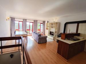 a large living room with a sink and a couch at Magoito Beach Apartment in Sintra