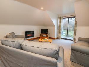 a living room with a couch and a tv at Campbell in Pitlochry