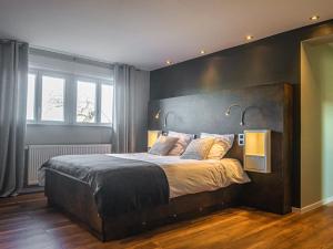 a bedroom with a large bed with two lights on it at Cozy holiday home in Lemberg in Lemberg