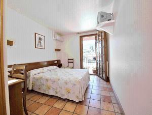 a bedroom with a bed and a large window at Hostal Lorentxo in Olave