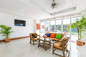 a living room with chairs and a table at Phusita Hotel - SHA Certified in Patong Beach