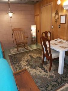 a dining room with a table and two chairs at Grandeur Farm Retreat in Marshallville