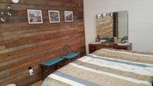 a hospital room with two beds and a mirror at Grandeur Farm Retreat in Marshallville