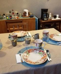 a table with plates and cups on top of it at Grandeur Farm Retreat in Marshallville +16 photos